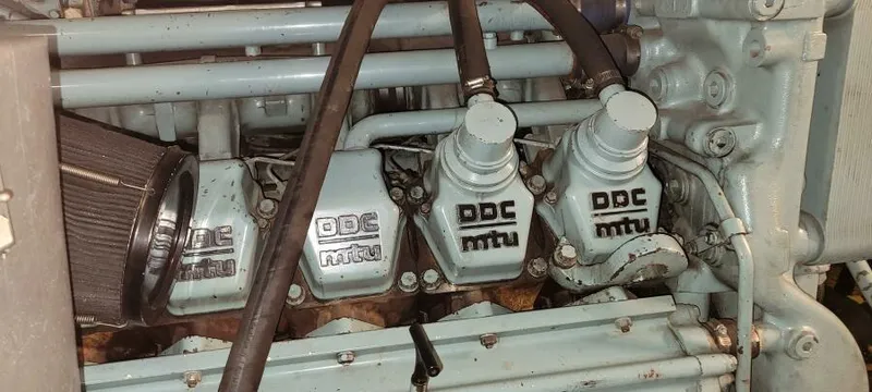 Slide: The Image of Engine components of a 1979 Blount 130 Dinner Cruise with DDC MTU branding. - 24