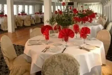 Slide: The Image of Elegant dining setup on Blount 130 Dinner Cruise, 1979, with red napkins and floral centerpieces. - 19