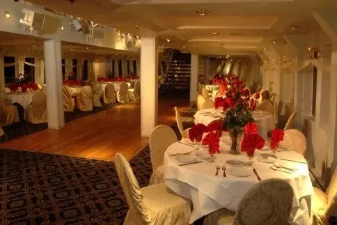 Slide: The Image of Luxurious dining area on the 1979 Blount 130 Dinner Cruise, elegantly set with red accents. - 20