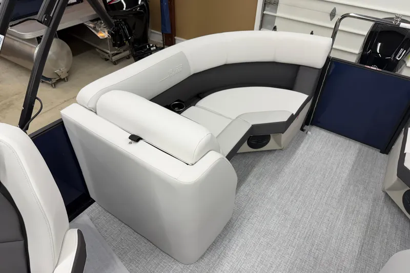 Slide: The Image of 2026 Harris Cruiser 210 CWDH boat interior with white and gray seating. - 10
