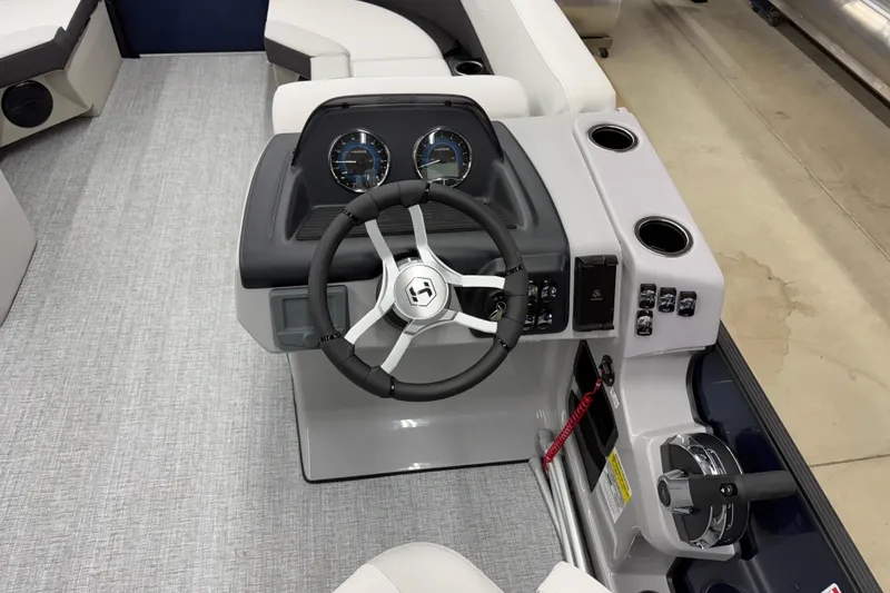 Slide: The Image of 2026 Harris Cruiser 210 CWDH boat dashboard with steering wheel and controls. - 11