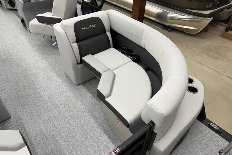Slide: The Image of 2026 Harris Cruiser 210 CWDH boat interior with plush seating and cup holders. - 12