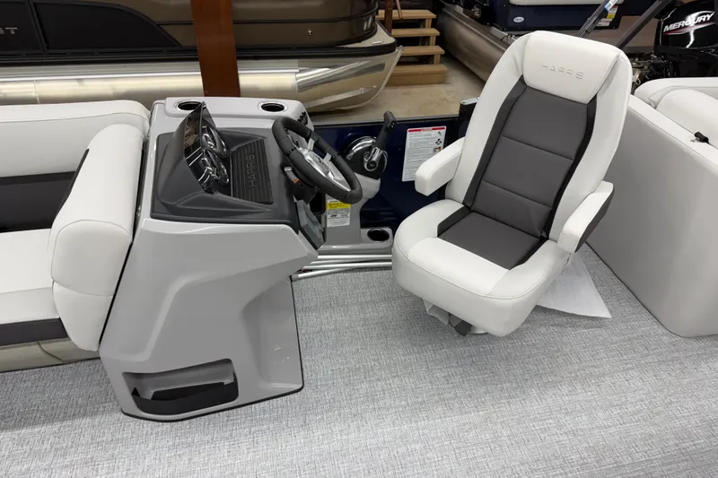 Slide: The Image of 2026 Harris Cruiser 210 CWDH boat interior with steering console and captain's chair. - 7
