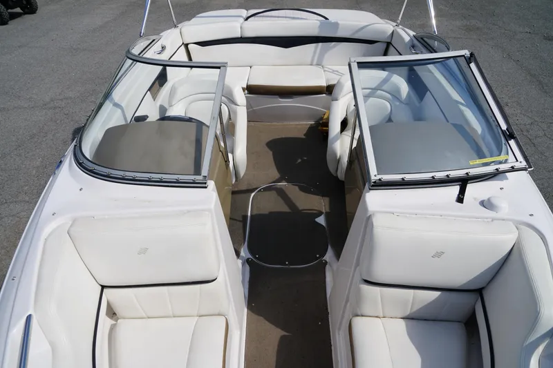 Slide: The Image of 2007 Four Winns 210 Horizon boat interior with white seating and open windshield. - 10