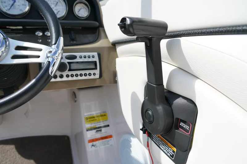 Slide: The Image of 2007 Four Winns 210 Horizon boat dashboard with steering wheel and control panel. - 11