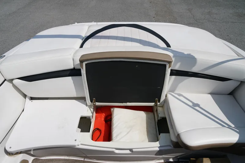 Slide: The Image of 2007 Four Winns 210 Horizon boat interior with open storage compartment and white seating. - 17