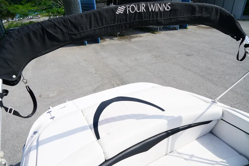 Slide: The Image of 2007 Four Winns 210 Horizon boat with white seating and black canopy. - 6