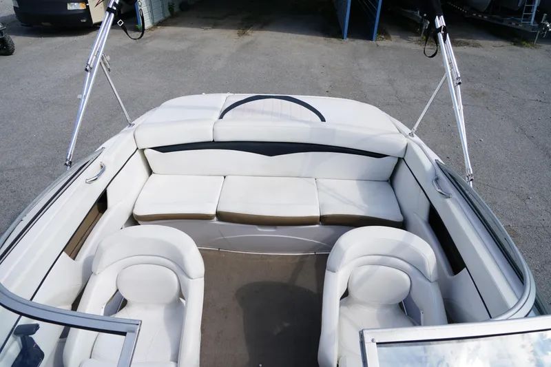 Slide: The Image of 2007 Four Winns 210 Horizon boat interior with white seating and open deck. - 7