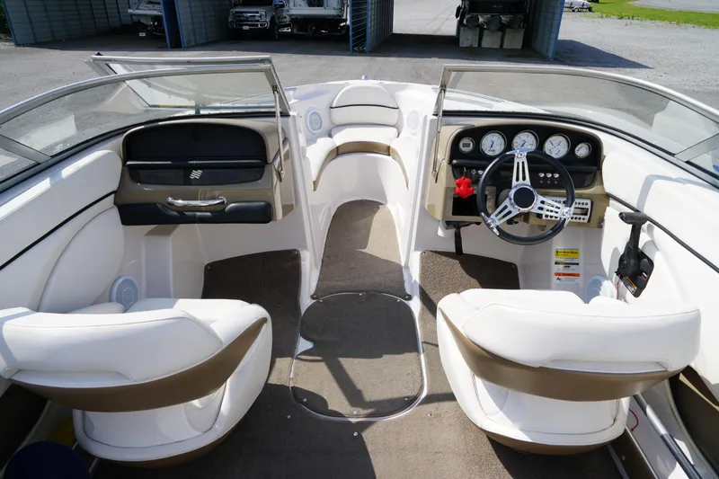 Slide: The Image of Interior view of a 2007 Four Winns 210 Horizon boat, featuring steering wheel and seating. - 8