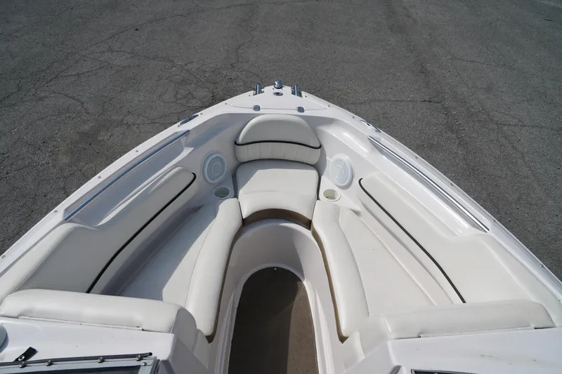 Slide: The Image of 2007 Four Winns 210 Horizon boat interior with white seating and cup holders. - 9