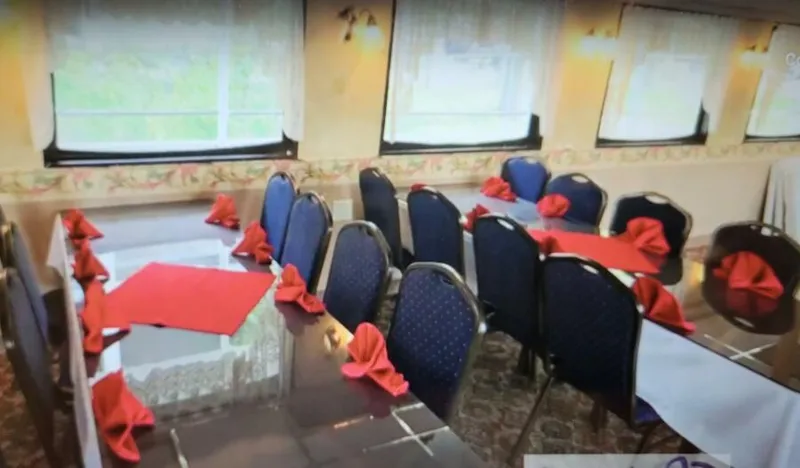 Slide: The Image of Elegant dining area with blue chairs and red napkins on a 1985 custom passenger excursion. - 9
