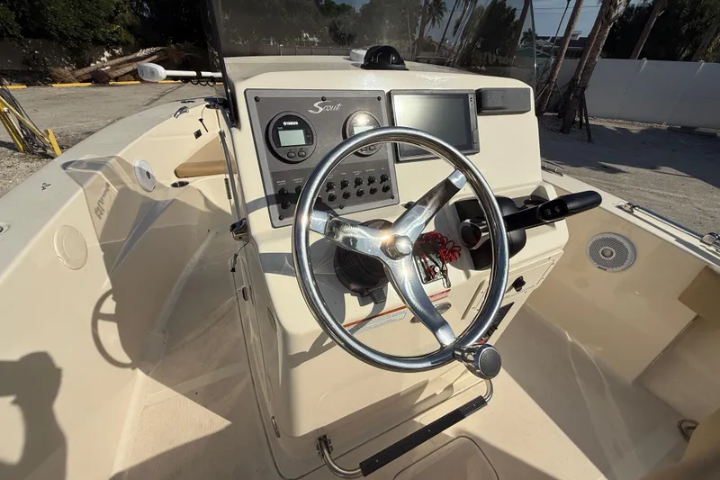 Slide: The Image of 2020 Scout 195 Sportfish boat dashboard with steering wheel and controls. - 3