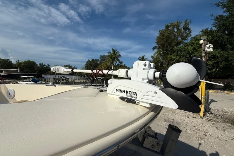 Slide: The Image of 2020 Scout 195 Sportfish with Minn Kota Terrova trolling motor, docked under clear skies. - 6