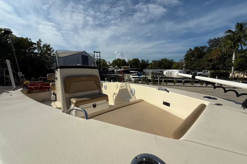 Slide: The Image of 2020 Scout 195 Sportfish boat docked under a clear blue sky. - 7