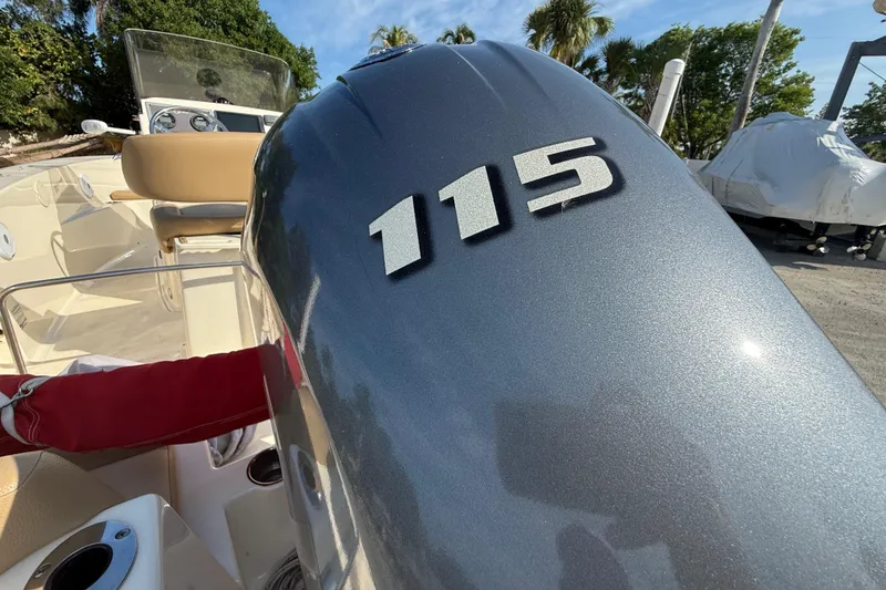 Slide: The Image of 2020 Scout 195 Sportfish boat with 115 horsepower engine, parked outdoors. - 8