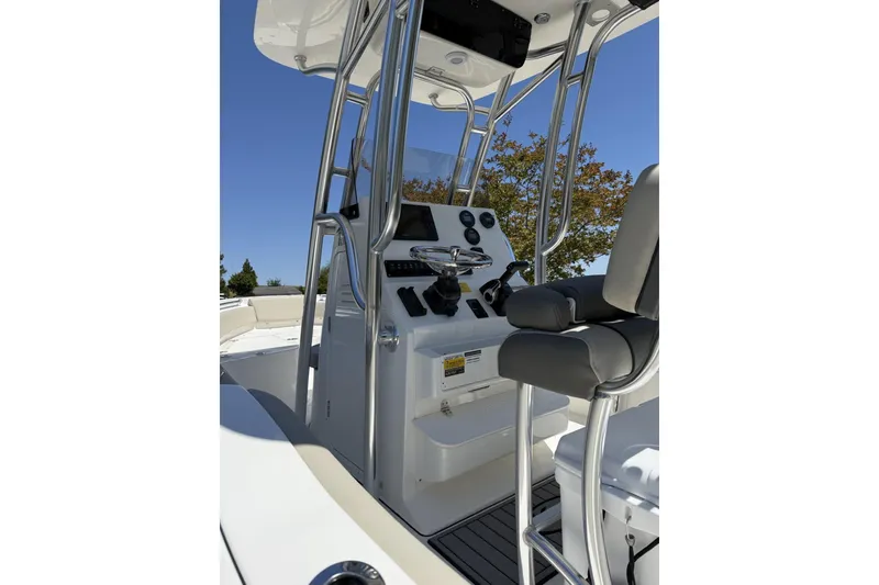 Slide: The Image of 2026 Key West 219 FS boat interior with steering console and seating. - 3