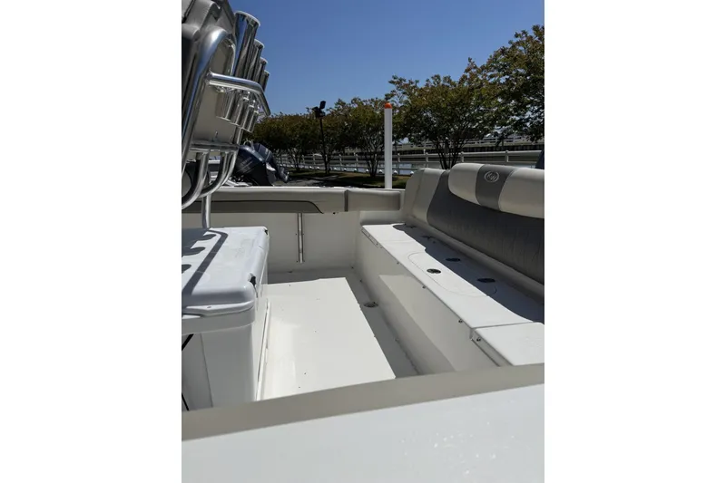 Slide: The Image of 2026 Key West 219 FS boat interior with seating and storage, under clear blue sky. - 4