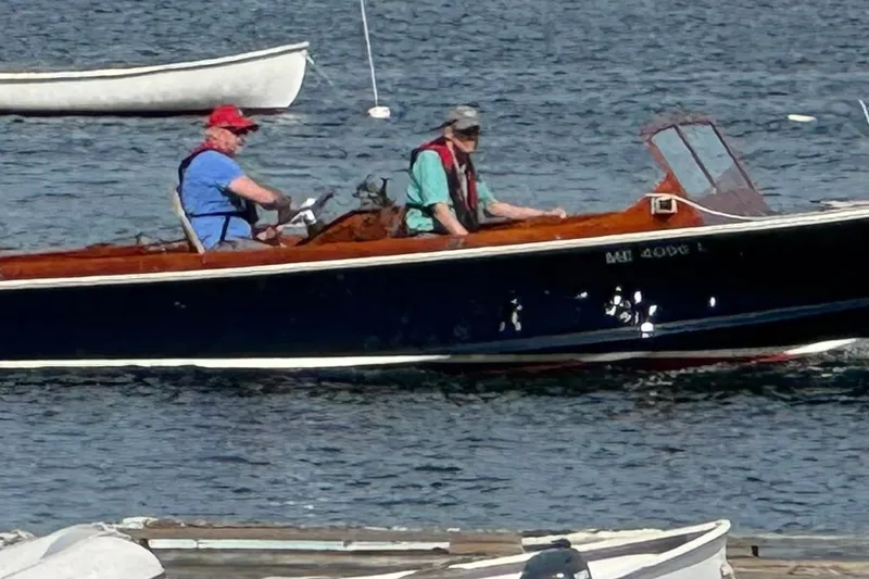 The Image of 1966 C Ray Hunt Surf Hunter boat with two people on a calm water surface. - 1