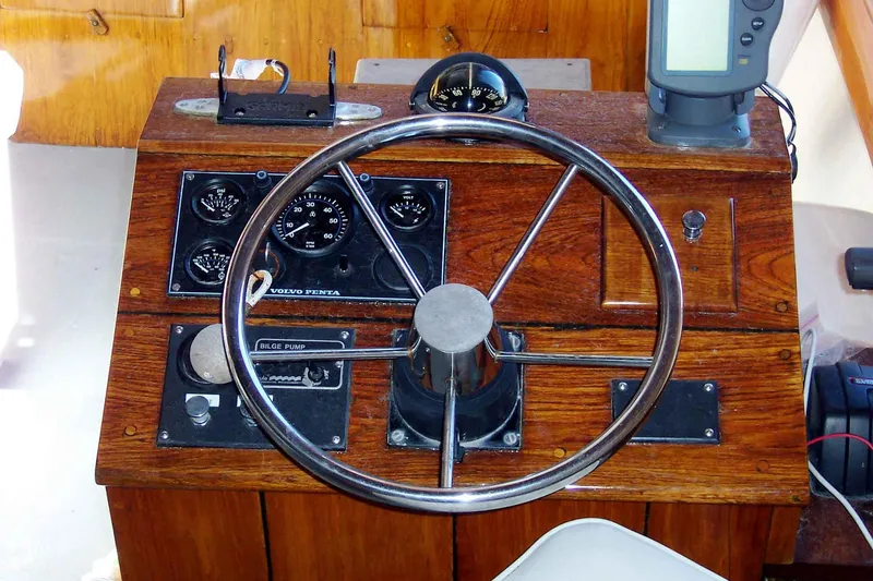 Slide: The Image of 1966 C Ray Hunt Surf Hunter boat helm with wooden dashboard and steering wheel. - 3