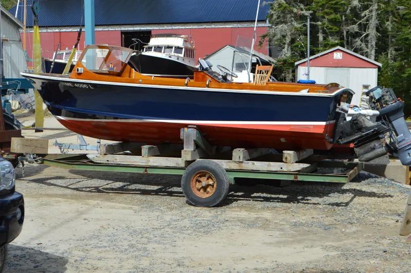 Slide: The Image of 1966 C Ray Hunt Surf Hunter boat on trailer, blue and red hull, dockside setting. - 4