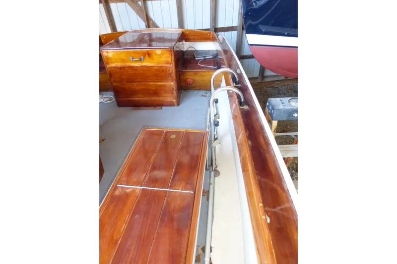 Slide: The Image of 1966 Custom Surf Hunter boat interior with polished wood finish and storage compartments. - 5