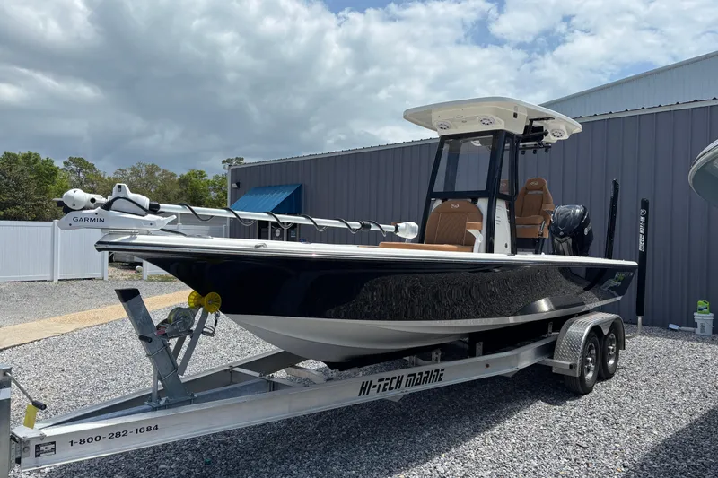 The Image of 2026 Key West 250 Bay Reef boat on trailer, parked outdoors near a building. - 0
