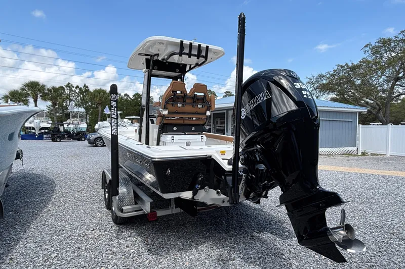 Slide: The Image of 2026 Key West 250 Bay Reef boat with Yamaha engine, parked on gravel lot. - 1