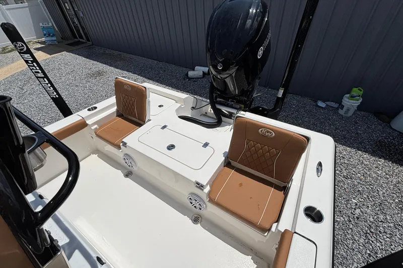Slide: The Image of 2026 Key West 250 Bay Reef boat interior with brown seating and Yamaha engine. - 10