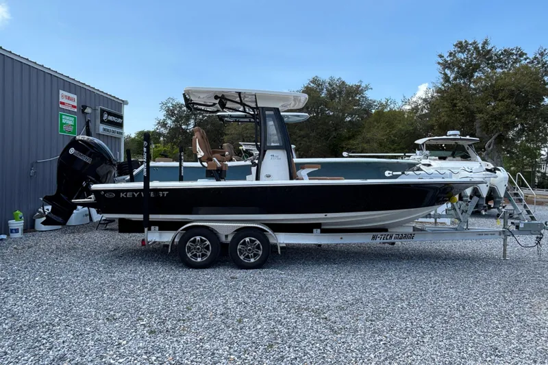 Slide: The Image of 2026 Key West 250 Bay Reef boat on trailer, parked outdoors. - 3