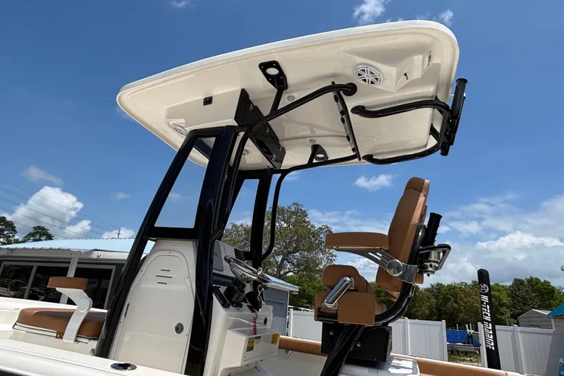 Slide: The Image of 2026 Key West 250 Bay Reef boat with T-top and captain's chair under blue sky. - 5