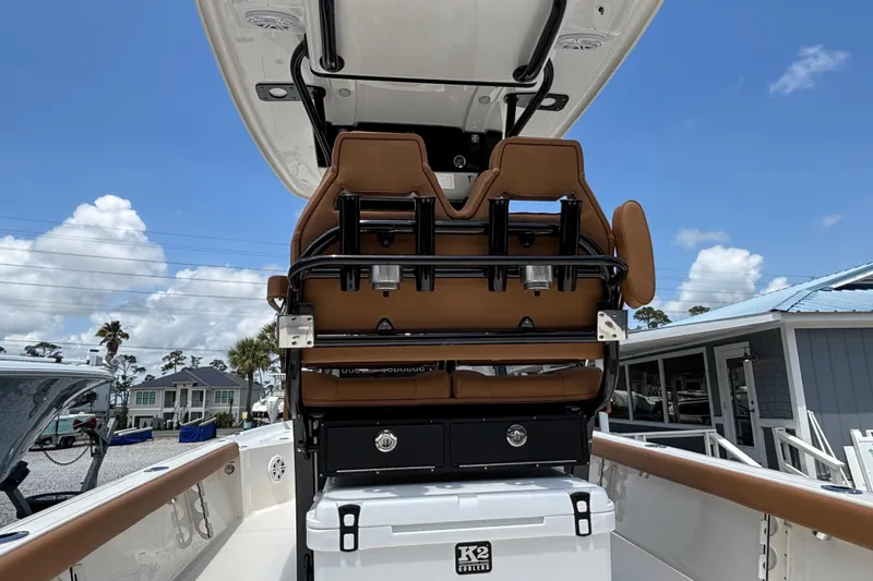 Slide: The Image of 2026 Key West 250 Bay Reef boat interior with brown seating and storage compartments. - 6