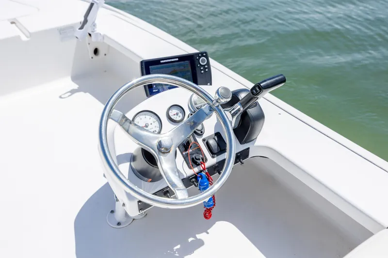 Slide: The Image of Steering console of 2018 Bomb Island 160 SC boat with navigation equipment. - 11