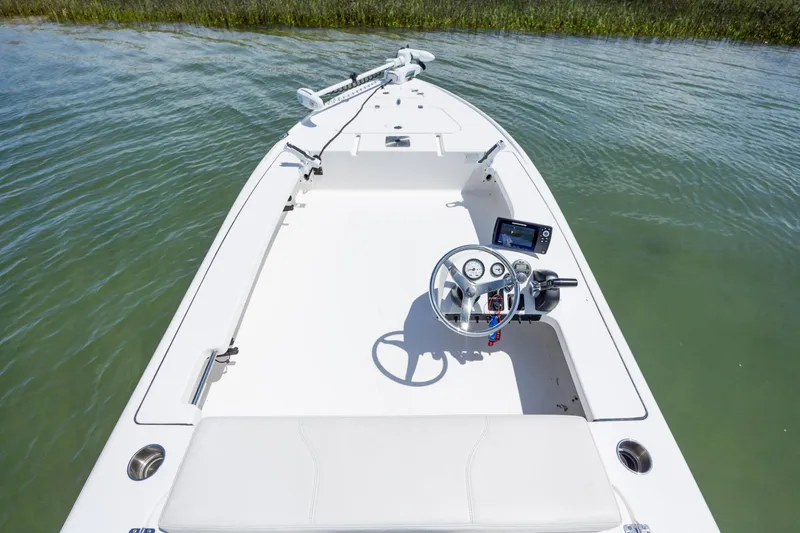 Slide: The Image of 2018 Bomb Island 160 SC boat interior with steering console on calm water. - 13