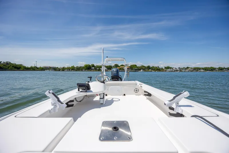 Slide: The Image of 2018 Bomb Island 160 SC boat on calm water under clear blue sky. - 15
