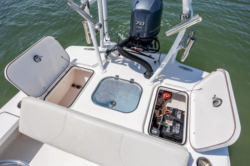Slide: The Image of 2018 Bomb Island 160 SC boat with open storage compartments and Yamaha engine. - 16
