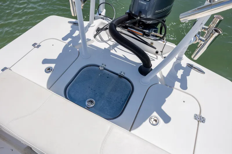 Slide: The Image of 2018 Bomb Island 160 SC boat deck with motor and storage compartments. - 17
