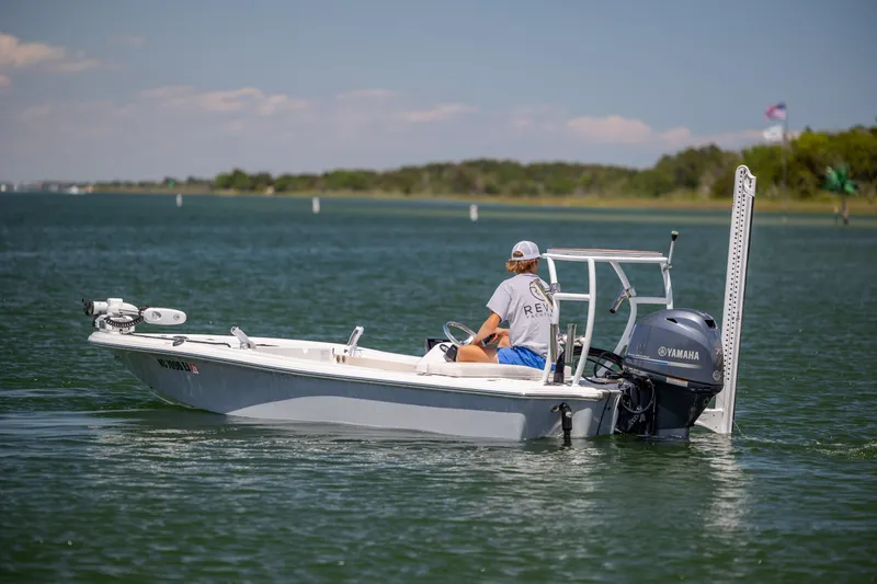 Slide: The Image of A 2018 Bomb Island 160 SC boat on a calm lake with a Yamaha motor. - 3