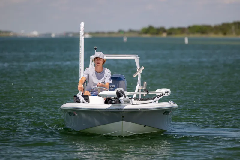 Slide: The Image of Man steering 2018 Bomb Island 160 SC boat on a calm lake. - 6