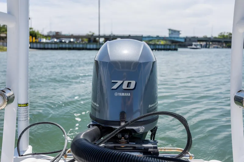 Slide: The Image of Outboard motor on 2018 Bomb Island 160 SC boat, cruising on a sunny day. - 9