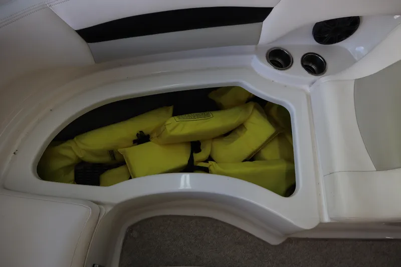 Slide: The Image of Storage compartment with yellow life jackets in a 2009 Chaparral Sunesta 244 boat. - 11