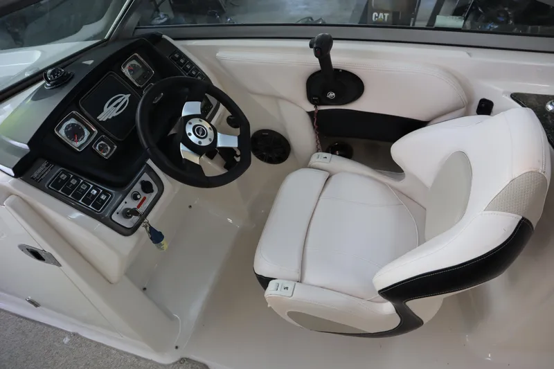 Slide: The Image of 2009 Chaparral Sunesta 244 boat cockpit with steering wheel and captain's chair. - 16