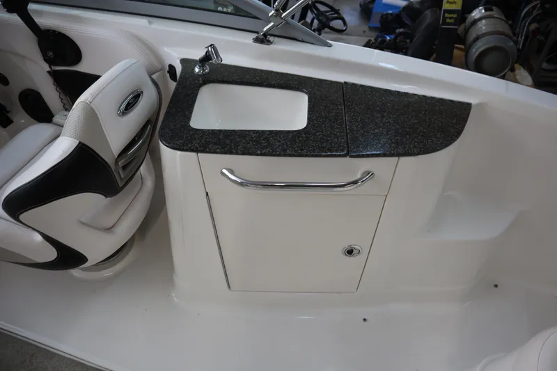 Slide: The Image of 2009 Chaparral Sunesta 244 boat interior with sink and seating area. - 18