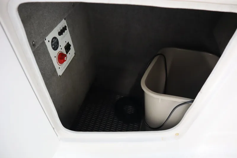 Slide: The Image of Storage compartment in a 2009 Chaparral Sunesta 244 boat with control panel and bucket. - 19