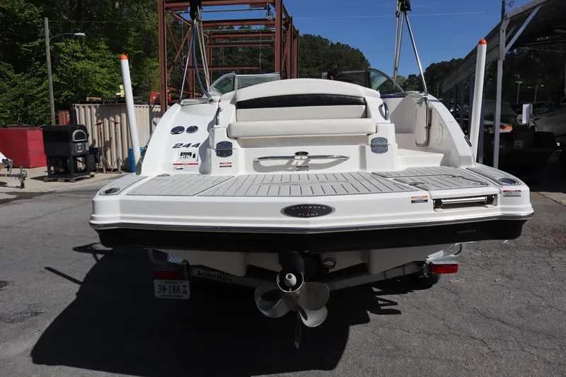 Slide: The Image of 2009 Chaparral Sunesta 244 boat rear view, showcasing swim platform and outboard motor. - 2