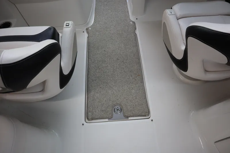 Slide: The Image of 2009 Chaparral Sunesta 244 interior with white and black seating and carpeted flooring. - 23
