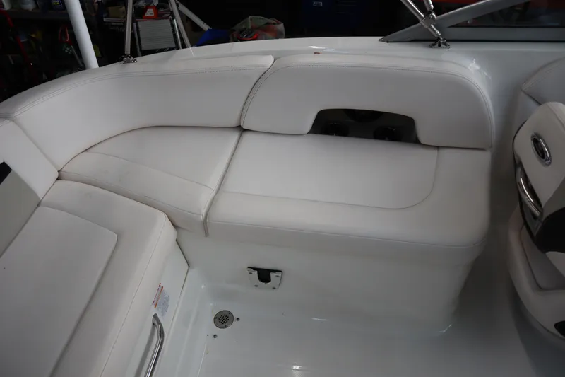 Slide: The Image of 2009 Chaparral Sunesta 244 boat interior with white seating and cup holders. - 25