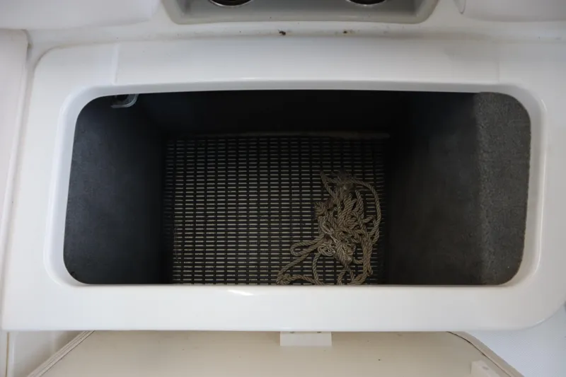 Slide: The Image of Storage compartment in a 2009 Chaparral Sunesta 244 boat with rope inside. - 26