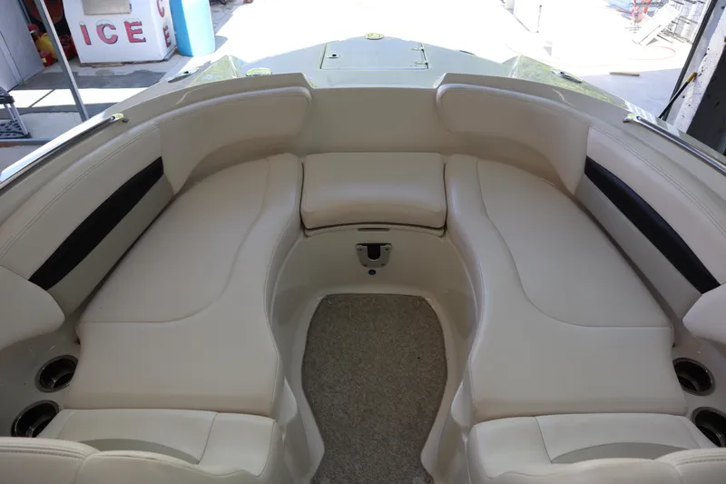 Slide: The Image of 2009 Chaparral Sunesta 244 boat interior with beige seating and cup holders. - 3