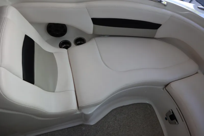 Slide: The Image of 2009 Chaparral Sunesta 244 boat interior seating with cup holders and speaker. - 6