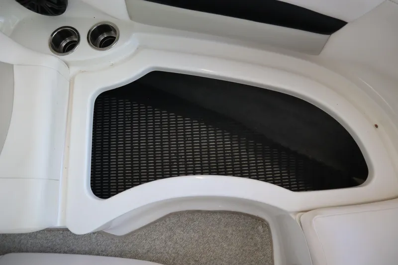 Slide: The Image of 2009 Chaparral Sunesta 244 boat interior with cup holders and storage area. - 7